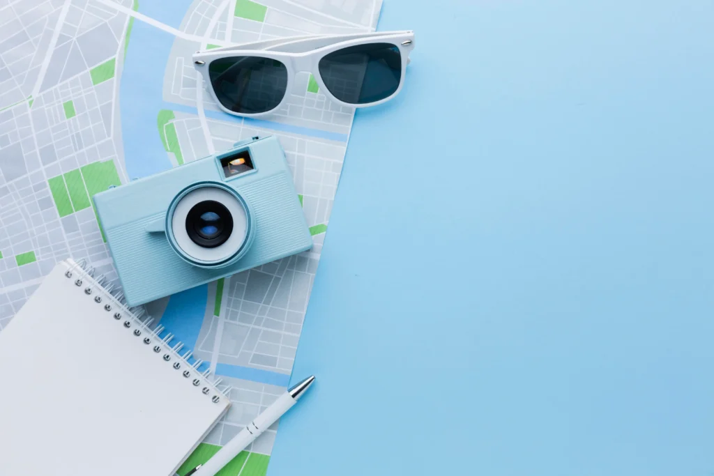Gafas de sol, mapa y camara fotográfica vista aerea